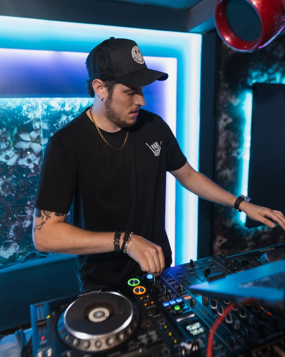 DJ in a blue-lit booth