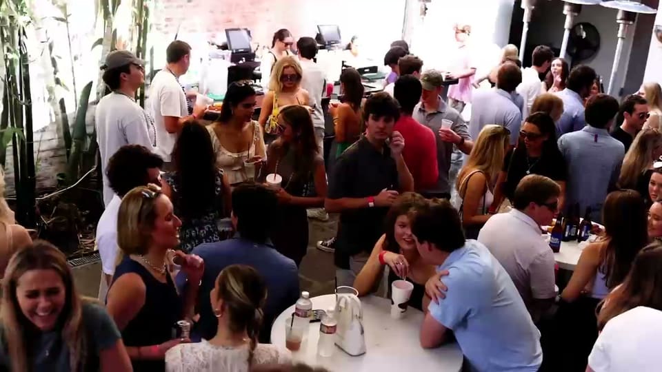 Crowded courtyard party during a New Orleans travel weekend